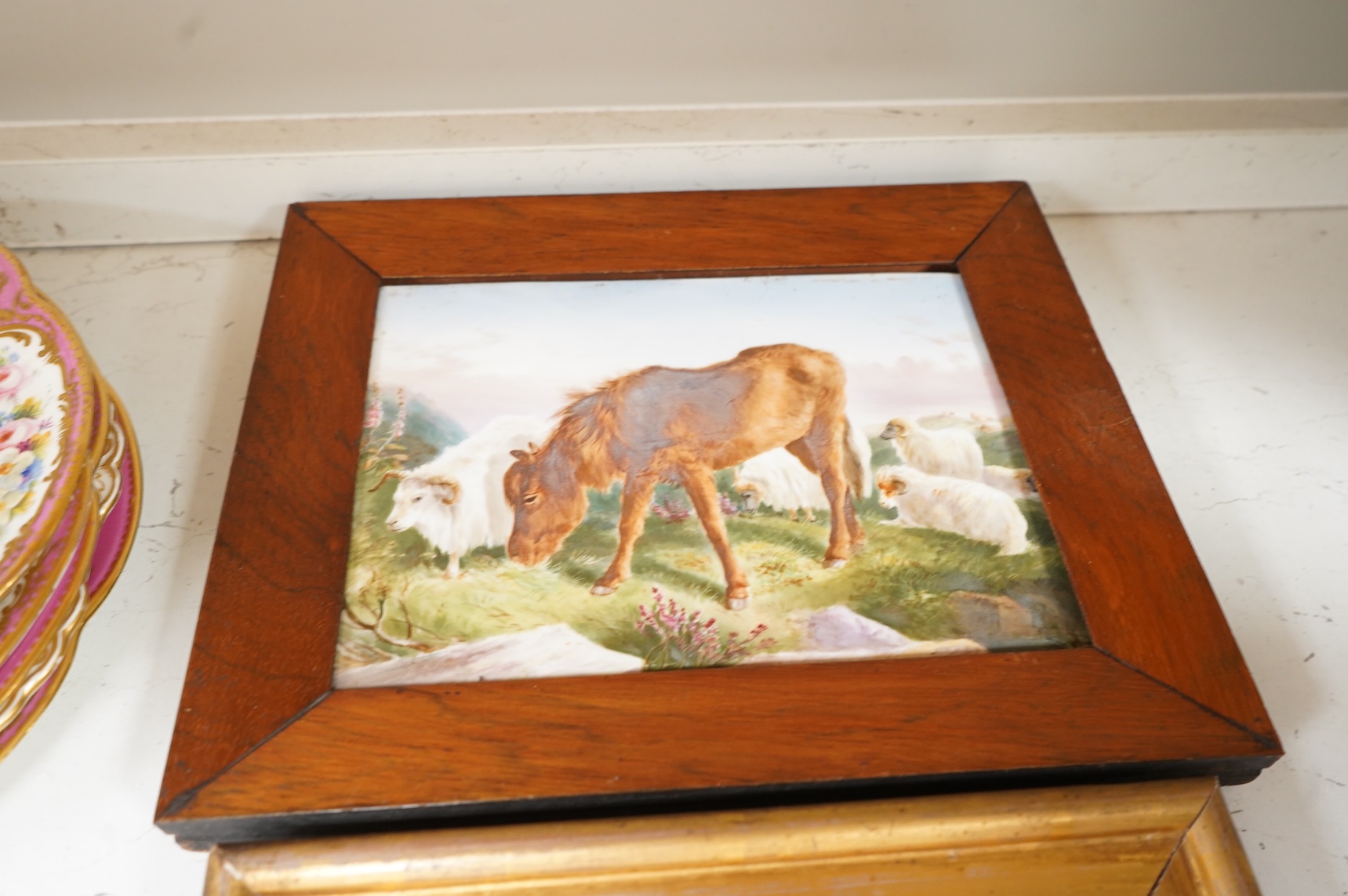 Four porcelain framed plaques, 19th and 20th century hand painted with highland landscapes and figures, two by James Skerrett, gilt framed, largest 21 x 26cm overall